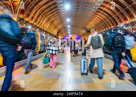 Passengers rush along a platform at Paddington Railway Station to board a train. Stock Photo