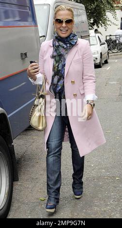 EXCLUSIVE!! Singer Anastacia is all smiles while out for a stroll in London wearing a pretty pink jacket with patterned scarf and gold metallic handbag. London, UK. 11/04/10. Stock Photo