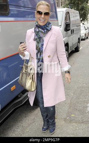 EXCLUSIVE!! Singer Anastacia is all smiles while out for a stroll in London wearing a pretty pink jacket with patterned scarf and gold metallic handbag. London, UK. 11/04/10. Stock Photo