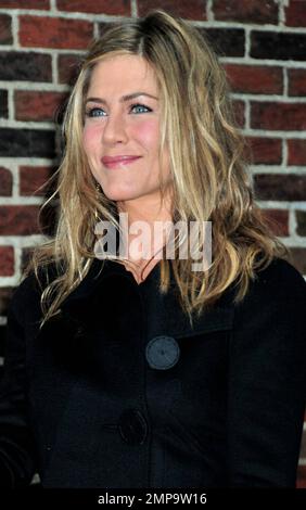 Jennifer Aniston poses for photos outside the 'Late Show with David Letterman' studios, where she made an appearance on the show to promote her new film 'The Bounty Hunter,' co-starring Gerard Butler. New York, NY. 3/15/10.     . Stock Photo