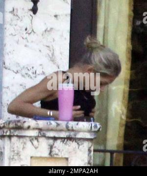 EXCLUSIVE!! Despite recent rumors of pregnancy, Anna Kournikova was spotted  on the balcony of her