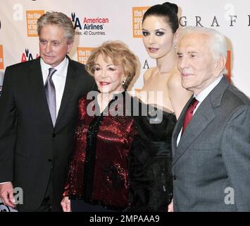 Actor couple Michael Douglas and Catherine Zeta-Jones, in a black sequin and tulle Marchesa cocktail dress, are joined by Michael's stepmother Anne Buydens and father, legendary actor Kirk Douglas at the Tully Hall Lincoln Center for the Film Society 37th Annual Chaplin Award gala where Michael was honored with this year's Chaplin Award. New York, NY. 05/24/10. Stock Photo