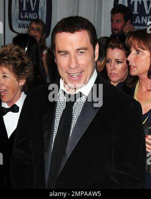 John Travolta appears in a great mood, and sports his hair weave, at the 9th Annual TV Land Awards, held at the Javits Center, and is joined by wife Kelly Preston and the cast of the 1970s TV series 'Welcome Back, Kotter'. New York, NY. 04/10/11. Stock Photo