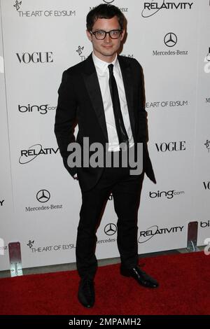 Elijah Wood in geek chic glasses on the red carpet at the star studded Art of Elysium fourth annual Heaven Charity Gala held at the California Science Center. Los Angeles, CA. 01/15/11. Stock Photo