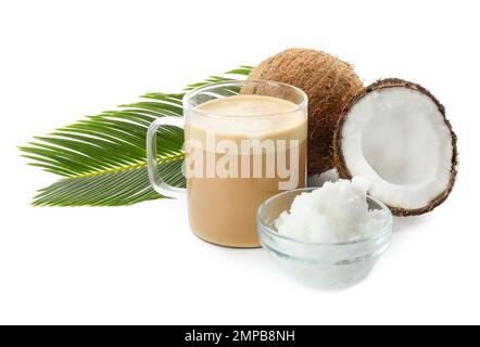 Delicious coffee with organic coconut oil and palm leaf isolated on white Stock Photo