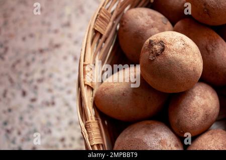 Manilkara zapota, commonly known as sapodilla in a bunch after harvesting Stock Photo