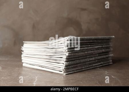 Stack of newspapers on marble table. Journalist's work Stock Photo