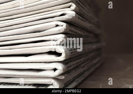 Stack of newspapers on table, closeup. Journalist's work Stock Photo