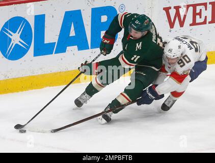 Minnesota Wild's Zach Parise, front left, attempts a shot on-goal which is  blocked by St. Louis Blues goalie Brian Elliott, right, as Blues' Alexander  Steen, back left, helps defend the net in