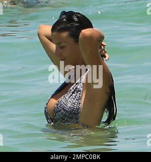 Manchester city soccer player Bacary Sagna enjoys the ocean with his wife Ludivine. Miami Beach, FL. July 18, 2014. Stock Photo