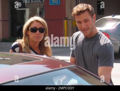 'The Bachelor' star Jake Pavelka and fiance Vienna Girardi kiss while out and about Robertson Blvd. doing some shopping with their friend Gia Allemand. Los Angeles, CA. 03/23/10.   . Stock Photo