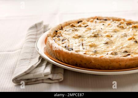 Chicken tart with mushrooms and cheese on a plate Stock Photo