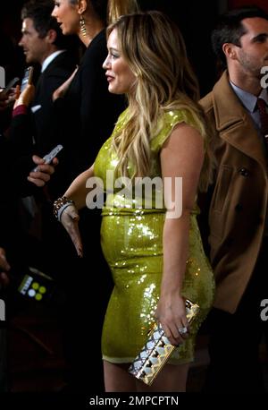 Actress Hilary Duff shows off her baby bump in a tight yellow dress at the launch of the Beauty Book for Brain Cancer at Grauman's Chinese Theatre in Hollywood, CA. 14th November 2011. Stock Photo