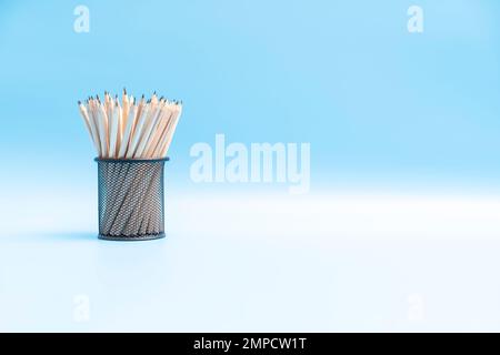 pencils in a pencil case on light blue background Stock Photo