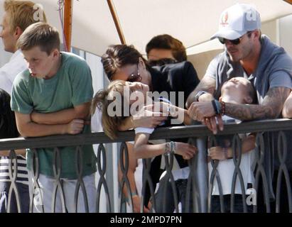 Footballer David Beckham, wife Victoria and their three sons Brooklyn, 11, Romeo, 8, and Cruz, 5, watch a free Jonas Brothers concert from a balcony at The Grove open-air shopping center.  The loving family stayed close to each other as they enjoyed the day.  Los Angeles, CA. 05/15/10. Stock Photo