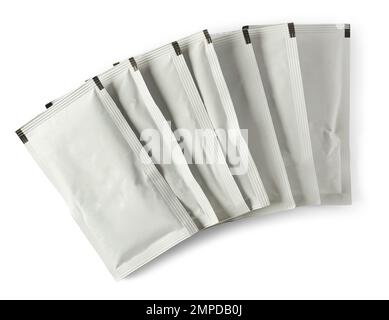 stack of blank white sachet packets isolated on white background, close-up of food or medicine drug packaging mockup template Stock Photo