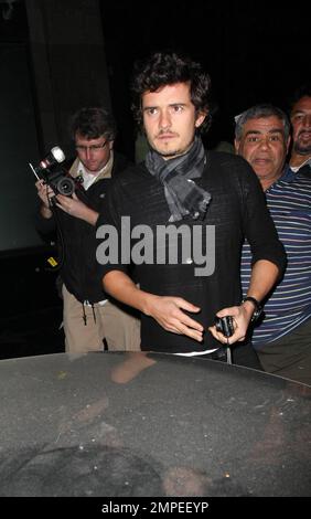 Actor Orlando Bloom continues his birthday celebrations with a night out on the town at Katusya in Los Angeles with his Victorias Secret model girlfriend Miranda Kerr.  The couple left amongst a throng of photographers but managed smiles for all.  They left in Blooms BMW v10 saloon that is in need of a good wash.  Lord of the Rings and Pirates of the Caribbean star Bloom turned 32 on January 13th.  Los Angeles, CA. 1/14/09. Stock Photo