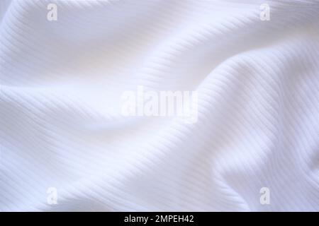 wrinkled white jersey, soft fabric background. Stock Photo