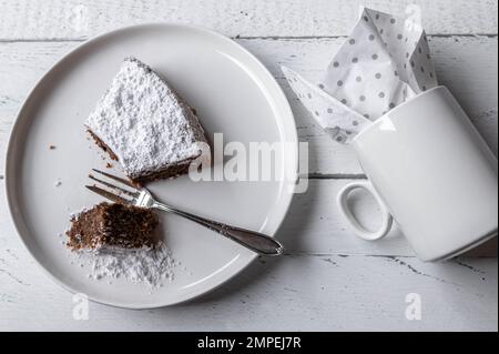 Slice of cake with cup isolated on white background. Flat lay Stock Photo