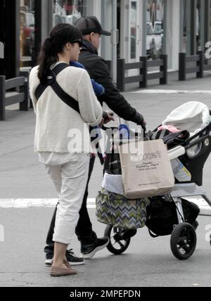 Actress Selma Blair is seen carrying her four month old son Arthur along with fashion designer boyfriend Jason Bleick who was pushing the baby stroller at the Malibu Country Mart where they did some shopping. It's been recently reported that the 'Cruel Intentions' star is suffering from post-partum hair loss, an unwanted side affect of pregnancy. She stated, 'This is so not glamorous, but itÕs true: I need to take longer showers so that I can collect the hair that falls out and throw it away so I donÕt clog the drain. Why do actresses never talk about that?' She continued with, 'It just starte Stock Photo