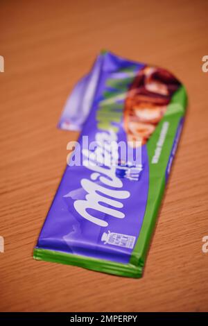 A vertical shot of Milka brand milk chocolate with whole hazelnuts Stock Photo