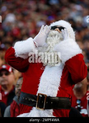 A Tennessee Titans fan is dressed as Santa as he watches the