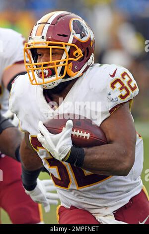 Washington Redskins running back Samaje Perine (32) takes a handoff from  quarterback Kirk Cousins (8) in the third quarter of a game against the Los  Angeles Chargers played at the StubHub Center