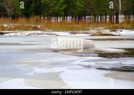 Spring is coming in Latvia. The ice is breaking on the river. A piece of ice has turned upright. The longest river in Latvia, Gauja. Stock Photo