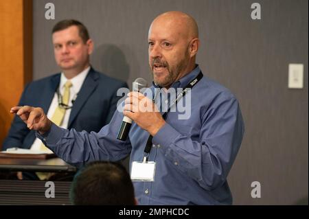 MCLEAN, Va. (Oct. 18, 2022) - Charles Tench, National Background Investigation Services (NBIS) program manager, answers a question from an industry security professional at the Defense Counterintelligence and Security Agency (DCSA) sponsored 2022 National Background Investigation Services (NBIS) Industry Conference. DCSA leaders and NBIS experts briefed cleared industry on NBIS program status; the impact on industry's feedback and partnership with DCSA; and onboarding requirements. NBIS is the backbone of the Trusted Workforce 2.0 whole-of-government background investigation reform effort over Stock Photo