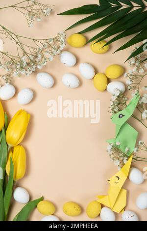 Happy Easter - layout with space for text center, Easter bunnies made of origami paper and eggs, top view Stock Photo