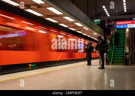 Blurred motion on an orange metro train in Hakaniemi metro station in Helsinki, Finland Stock Photo