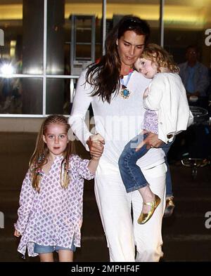 Brooke Shields arrives at LAX with her two adorable daughters Rowan and Grier. Rowan was sporting braids in her hair while the younger Grier got a ride with mom. Los Angeles, Ca. 6/20/09. Stock Photo