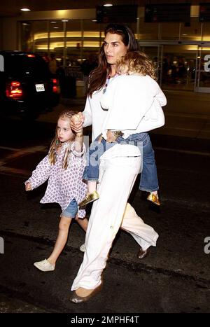 Brooke Shields arrives at LAX with her two adorable daughters Rowan and Grier. Rowan was sporting braids in her hair while the younger Grier got a ride with mom. Los Angeles, Ca. 6/20/09. Stock Photo