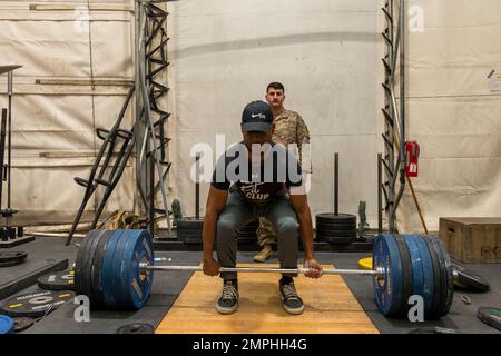 Soldiers in the 801st Field Hospital who are part of Joint Task Force Med 374 competed in the 500lb/1000lb weight lifting competition in Baghdad, Iraq. The rules are, you get three attempts to lift as much weight as you can at three stations; the bench press, deadlift and the squat. Females had to lift a combined weight of over 500lbs, men who weigh less than 165lbs must lift a combined weight of over 750lbs and men who weigh over 165lbs must lift a combined weight of over 1000lbs. Spc. Marshon Jones deadlifts 465lbs for his max weight. Stock Photo