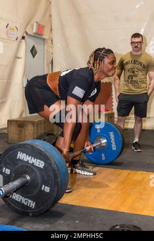 Soldiers in the 801st Field Hospital who are part of Joint Task Force Med 374 competed in the 500lb/1000lb weight lifting competition in Baghdad, Iraq. The rules are, you get three attempts to lift as much weight as you can at three stations; the bench press, deadlift and the squat. Females had to lift a combined weight of over 500lbs, men who weigh less than 165lbs must lift a combined weight of over 750lbs and men who weigh over 165lbs must lift a combined weight of over 1000lbs. Sgt. Grace Scott deadlifts 260lbs for her max attempt at this station. Stock Photo