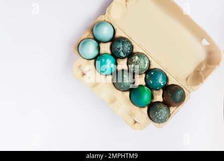 Colorful Easter eggs in cardboard box. Traditional festive decor. Stock Photo