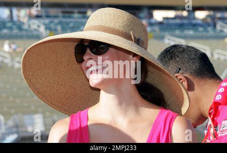 Actress Ashley Judd, wife of competing race car driver Dario Franchitti, was a classic vision amid the sweat and dirt of the pit road at Homestead-Miami Speedway.  Judd held her own and appeared very happy and confident in her bright pink sundress, espadrille heels, sunglasses and marvelous wide-brimmed sunhat.  At one point Judd was given a lift on a tire truck from which she watched her husband's qualifying run during the Cafe do Brasil Indy 300 held at the Homestead-Miami Speedway.  Homestead, FL. 10/01/10. Stock Photo