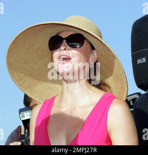 Actress Ashley Judd, wife of competing race car driver Dario Franchitti, was a classic vision amid the sweat and dirt of the pit road at Homestead-Miami Speedway.  Judd held her own and appeared very happy and confident in her bright pink sundress, espadrille heels, sunglasses and marvelous wide-brimmed sunhat.  At one point Judd was given a lift on a tire truck from which she watched her husband's qualifying run during the Cafe do Brasil Indy 300 held at the Homestead-Miami Speedway.  Homestead, FL. 10/01/10. Stock Photo