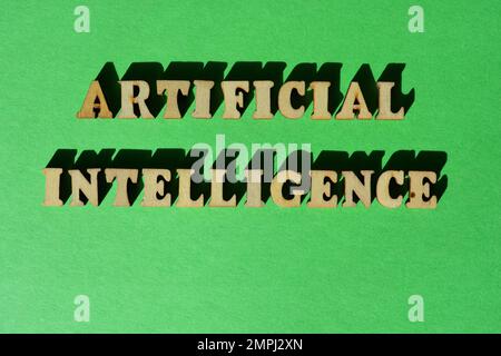 Artificial Intelligence, words in wooden alphabet letters isolated on bright green background Stock Photo
