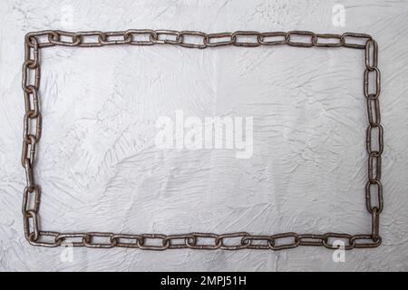 Continuous chain frame flat lay on gray cement background, template design Stock Photo