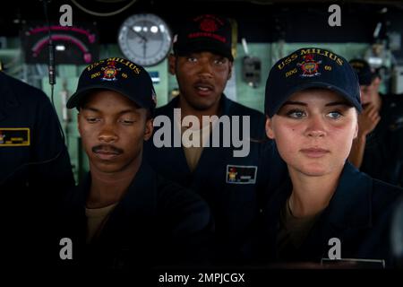 MORO GULF (Oct. 26, 2022) Seaman Jalen Bryant from Newport News, Virginia, Seaman Juan Camacho from Fantino, Dominican Republic, and Boatswain’s Mate Seaman Gracie Kuhns from Pocola, Oklahoma, stand watch on the bridge aboard Arleigh Burke-class guided-missile destroyer USS Milius (DDG 69) during transit through the Basilan Strait while operating in the Moro Gulf, Oct. 26. Milius is assigned to Commander, Task Force 71/Destroyer Squadron (DESRON) 15, the Navy’s largest forward-deployed DESRON and the U.S. 7th Fleet’s principal surface force. Stock Photo