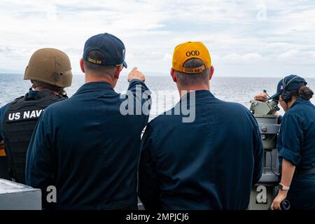 MORO GULF (Oct. 26, 2022) Sailors aboard Arleigh Burke-class guided-missile destroyer USS Milius (DDG 69) stand watch during transit through the Basilan Strait while operating in the Moro Gulf, Oct. 26. Milius is assigned to Commander, Task Force 71/Destroyer Squadron (DESRON) 15, the Navy’s largest forward-deployed DESRON and the U.S. 7th Fleet’s principal surface force. Stock Photo