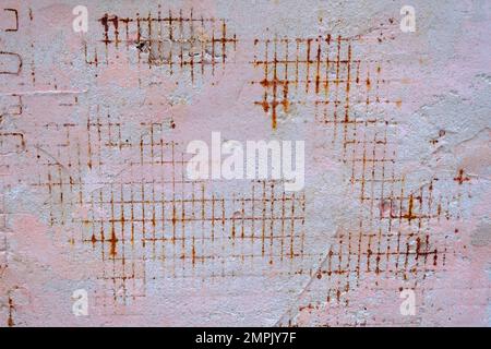 Rough concrete wall background with rusty wire rebar. Damaged wall background. Stock Photo
