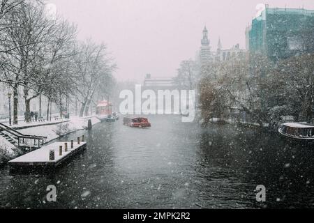 Amsterdam - February 2016: Amsterdam Canal in the middle of a snowstorm. Stock Photo