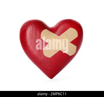 Red wooden heart with sticking plasters isolated on white Stock Photo