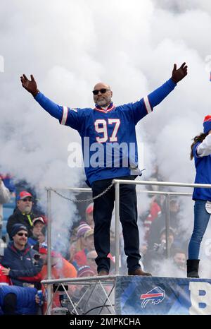 Buffalo Bills linebacker Cornelius Bennett, right, helps Houston Oilers  quarterback Warren Moon to his feet after sacking him in the third quarter  of their AFC playoff game at Rich Stadium in Orchard