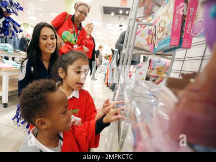 IMAGE DISTRIBUTED FOR JCPENNEY - Dallas Cowboys linebacker Sean Lee, left,  shops alongside Ajion Lair, 18, from the Boys & Girls Club of Greater  Dallas as he selects gifts for his family