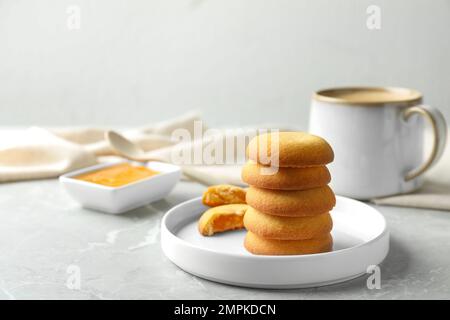 Tasty shortbread cookies with filling on light grey marble table Stock Photo