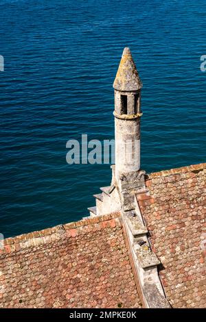 View on Lake Geneva over the roofs with a small tower of Chillon Castle, Château de Chillon. Stock Photo