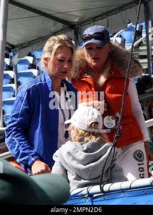 Tennis great Anna Kournikova (L) talks with her mother Alla and brother Allan prior to the Chris Evert Pro-Celebrity Tennis Classic at the Delray Beach Tennis Center in Delray Beach, FL. 11/07/10. Stock Photo